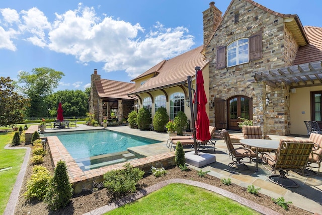 outdoor pool with a patio area and a pergola