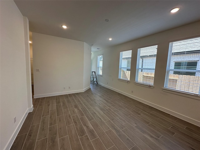 unfurnished room featuring wood finish floors, baseboards, and recessed lighting