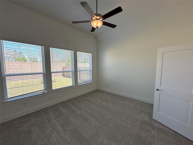 spare room featuring carpet flooring, ceiling fan, baseboards, and vaulted ceiling