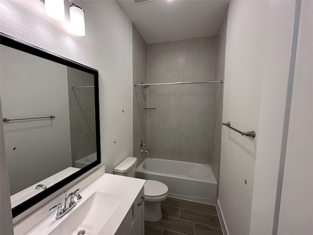 full bathroom featuring visible vents, tub / shower combination, baseboards, toilet, and vanity