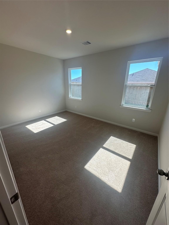 carpeted empty room featuring recessed lighting, baseboards, and visible vents