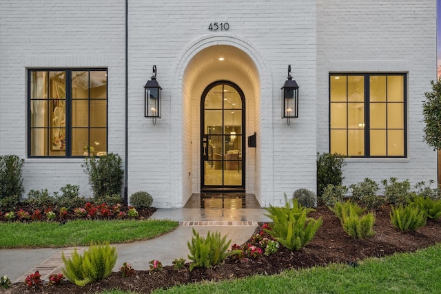 doorway to property with brick siding