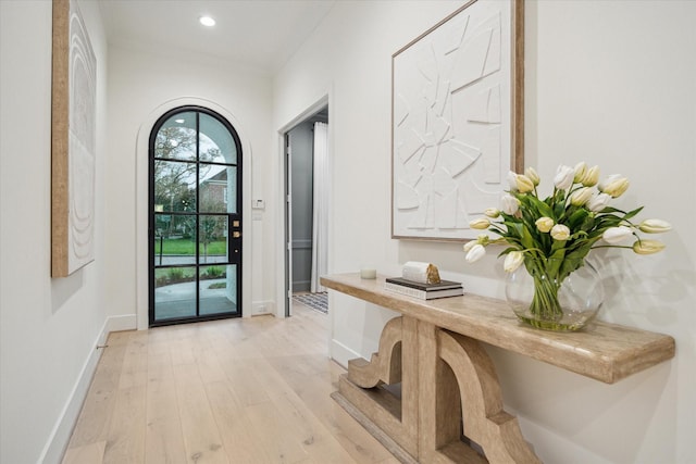 doorway featuring recessed lighting, light wood-type flooring, and baseboards