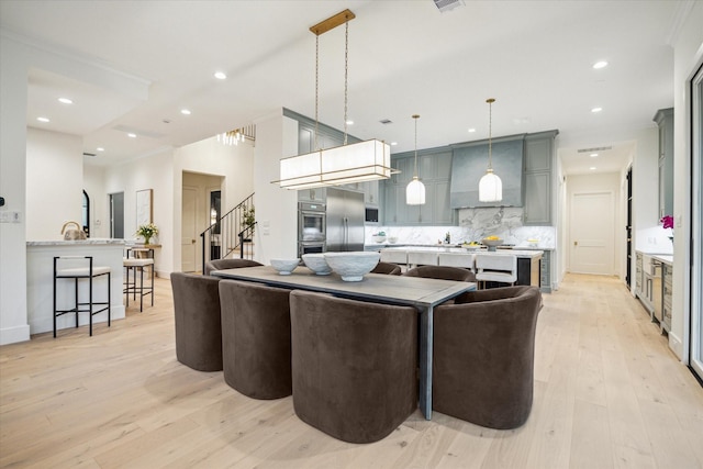 living room featuring recessed lighting, stairs, light wood-style floors, and ornamental molding