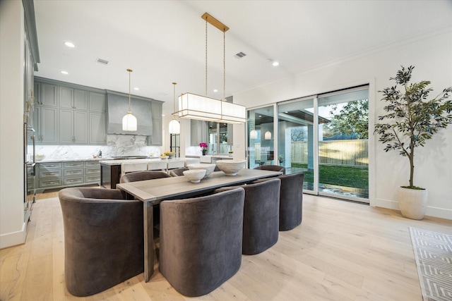 living room with recessed lighting, visible vents, baseboards, and light wood-style floors