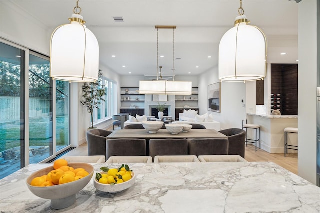 living room featuring recessed lighting, light wood-type flooring, and visible vents