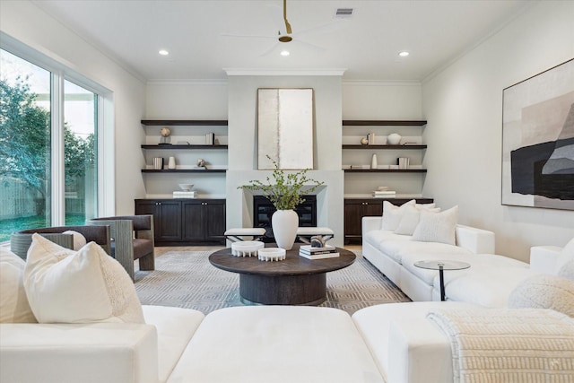 living area with visible vents, recessed lighting, crown molding, and a ceiling fan