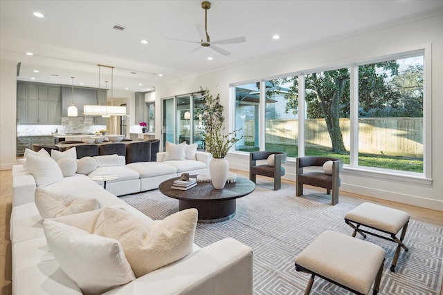 living room featuring light wood-style flooring, recessed lighting, visible vents, and ceiling fan