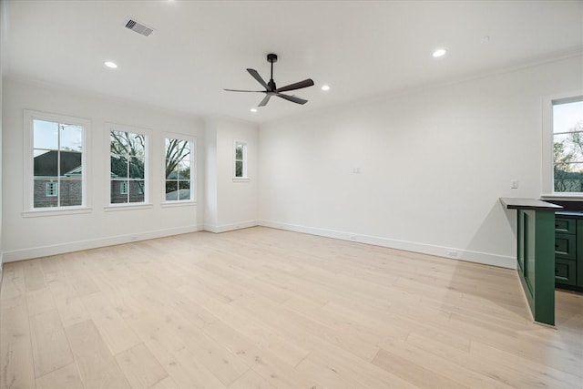 unfurnished living room with visible vents, light wood-style flooring, recessed lighting, ornamental molding, and ceiling fan