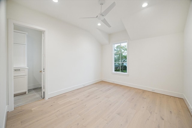 additional living space with vaulted ceiling, baseboards, light wood-type flooring, and ceiling fan