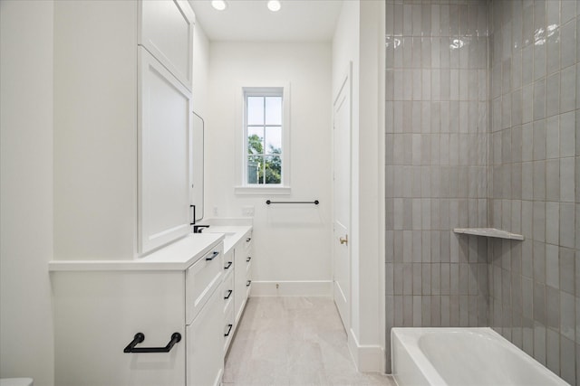 bathroom with recessed lighting, vanity, and baseboards