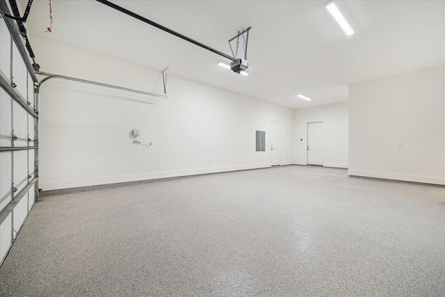 garage with a garage door opener and baseboards