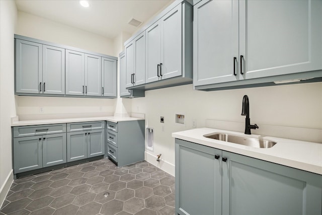 laundry area with hookup for a washing machine, cabinet space, electric dryer hookup, a sink, and hookup for a gas dryer