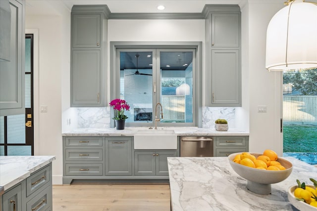 kitchen with gray cabinets, dishwasher, and a sink