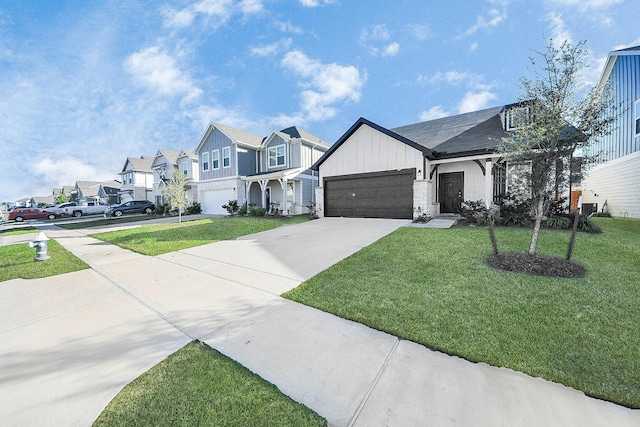 view of front of house with board and batten siding, a front lawn, a residential view, and driveway