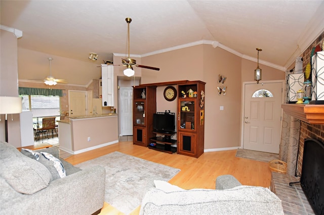 living room with vaulted ceiling, light wood-type flooring, and ornamental molding