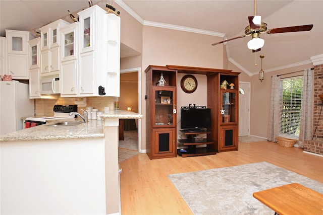 kitchen featuring decorative backsplash, white appliances, white cabinets, and crown molding