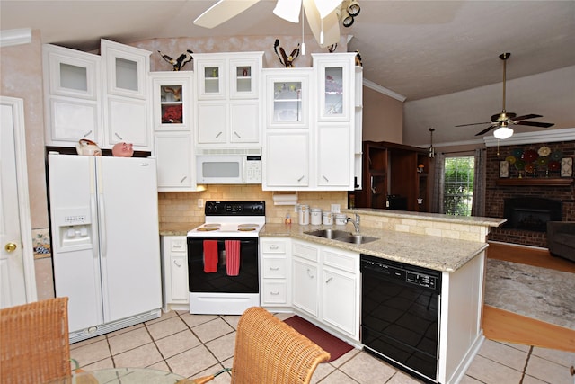 kitchen featuring open floor plan, a peninsula, light tile patterned flooring, white appliances, and a sink