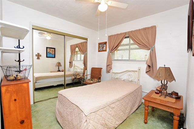 bedroom featuring ceiling fan, a closet, and light carpet