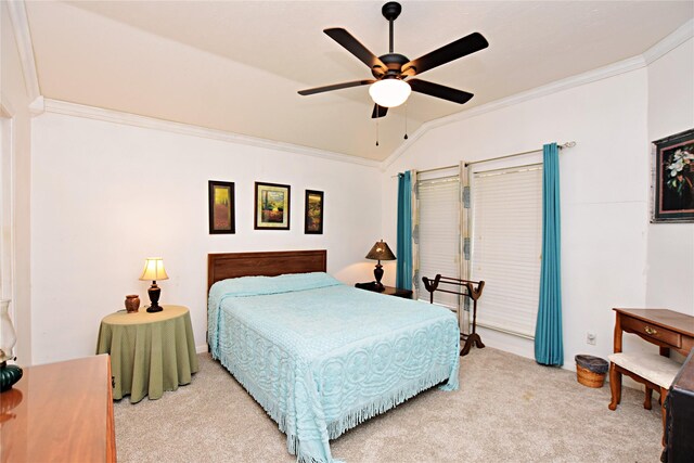 carpeted bedroom with ceiling fan, lofted ceiling, and ornamental molding