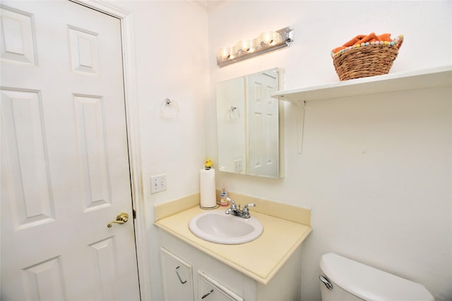 half bathroom with toilet and vanity