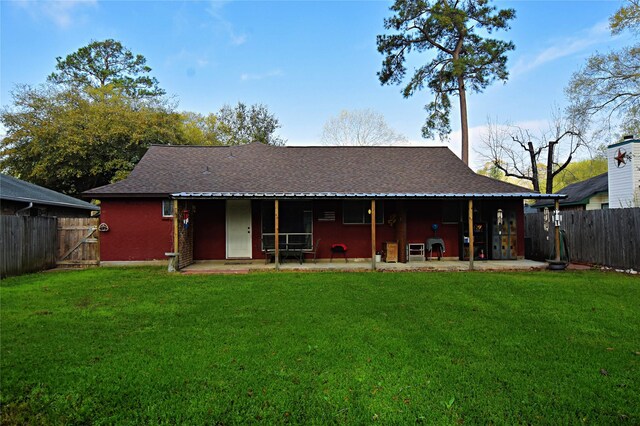 back of house featuring a fenced backyard, brick siding, and roof with shingles