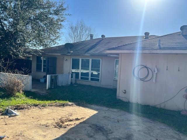 back of house with stucco siding