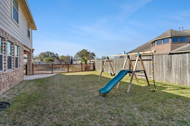 view of yard with a playground and a fenced backyard