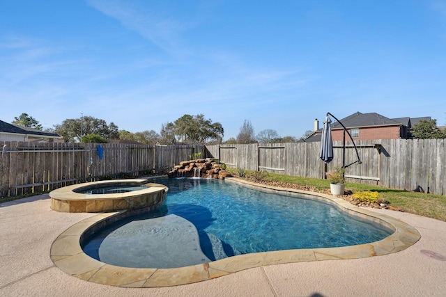 view of swimming pool featuring a fenced backyard and a pool with connected hot tub