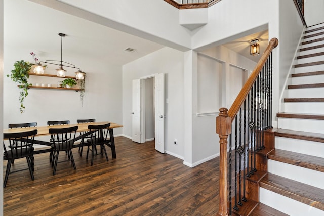 dining room featuring visible vents, stairway, dark wood-type flooring, and baseboards