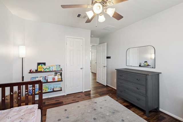 bedroom featuring visible vents, a ceiling fan, dark wood-type flooring, and baseboards