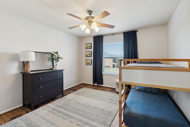 bedroom featuring ceiling fan, baseboards, and wood finished floors