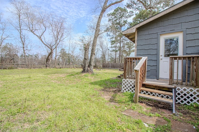 view of yard featuring a deck and fence