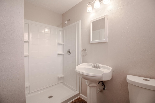 full bathroom with toilet and walk in shower