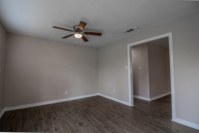 unfurnished room featuring visible vents, ceiling fan, dark wood-type flooring, and baseboards