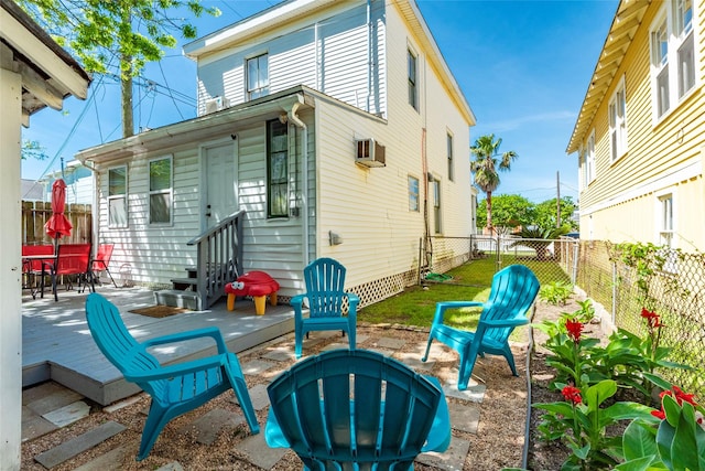 back of property featuring a deck, a fenced backyard, and entry steps