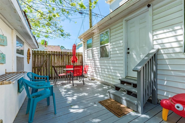 deck featuring outdoor dining space and fence