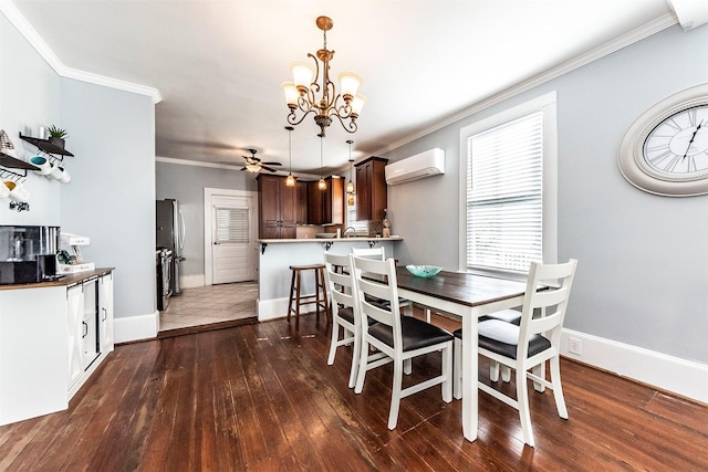 dining room with a wall mounted air conditioner, ceiling fan with notable chandelier, hardwood / wood-style flooring, crown molding, and baseboards