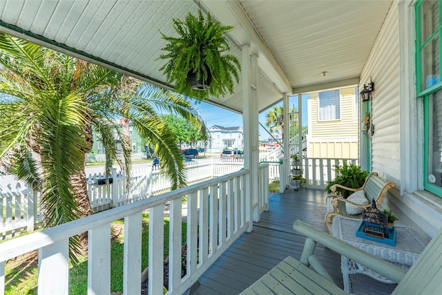 deck with a porch and fence