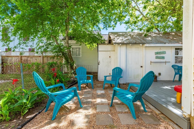 view of patio featuring a deck and fence