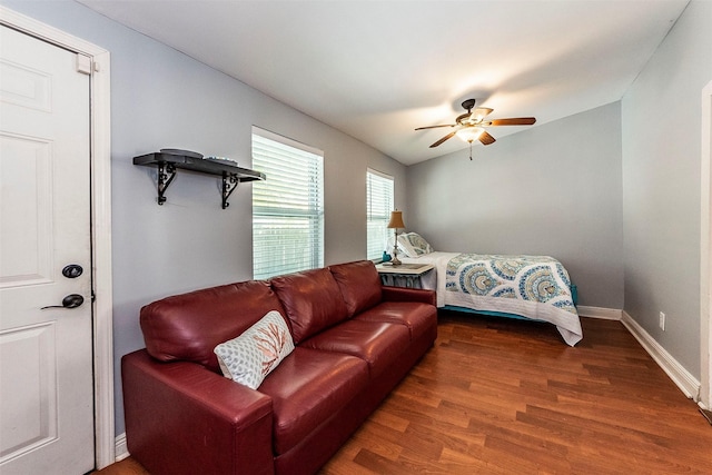 bedroom with ceiling fan, baseboards, and wood finished floors