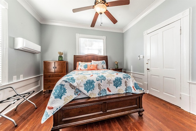 bedroom featuring dark wood-style floors, crown molding, and a wall mounted AC