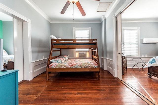 bedroom featuring crown molding, multiple windows, and a wainscoted wall