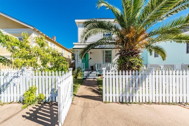 view of front of property featuring a fenced front yard and covered porch