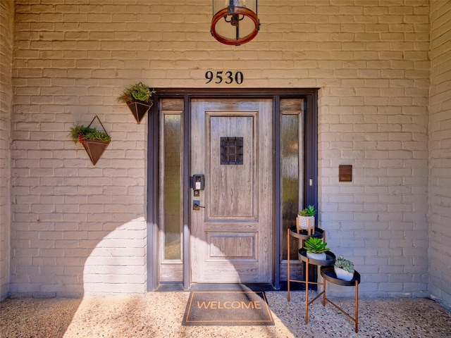 entrance to property with brick siding