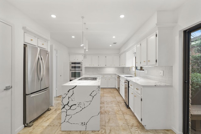 kitchen featuring tasteful backsplash, a center island, light stone countertops, stainless steel appliances, and a sink