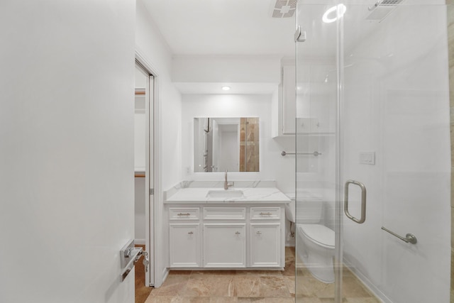 bathroom featuring visible vents, toilet, a stall shower, and vanity