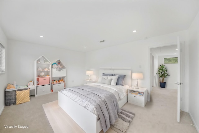 bedroom featuring recessed lighting, visible vents, light carpet, and attic access