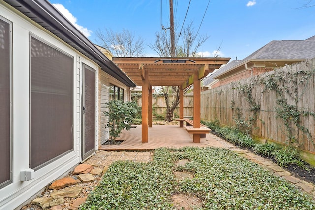 view of yard featuring a deck, a fenced backyard, and a pergola