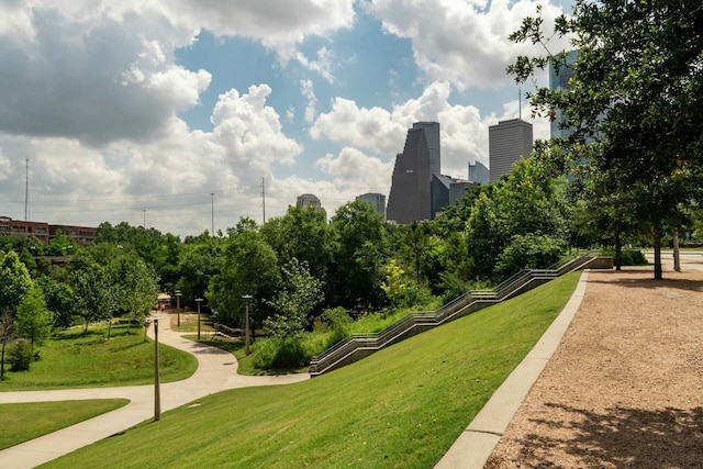 view of home's community with a view of city and a lawn